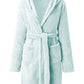 Green fleece hooded robe with belted waist and relaxed fit for comfort.
