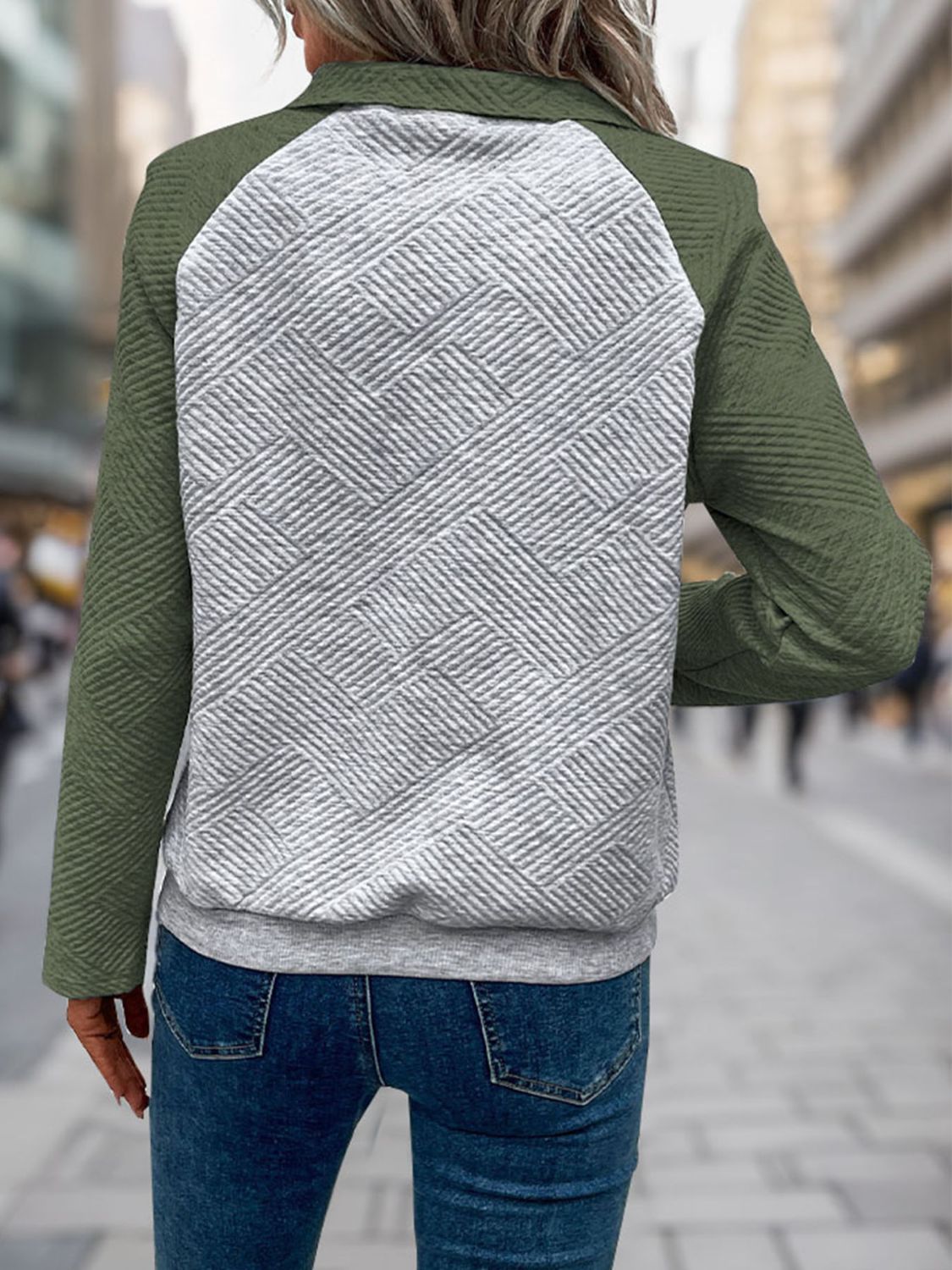 Green quilted pullover styled for casual wear with jeans