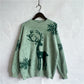 Front view of a cozy green sweater featuring a festive reindeer and snowflake design, perfect for the holidays.

