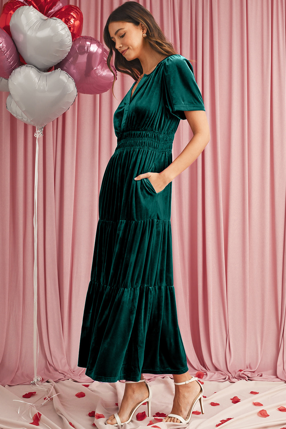 Luxurious green velvet maxi dress with flattering shirred waist and pockets
