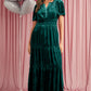 Front view of green velvet tiered maxi dress with shirred waist
