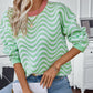 Full-length view of the green wavy stripe sweater, a fun and comfy choice for everyday wear.

