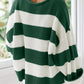 Cozy green striped pullover with a retro-inspired vibe.
