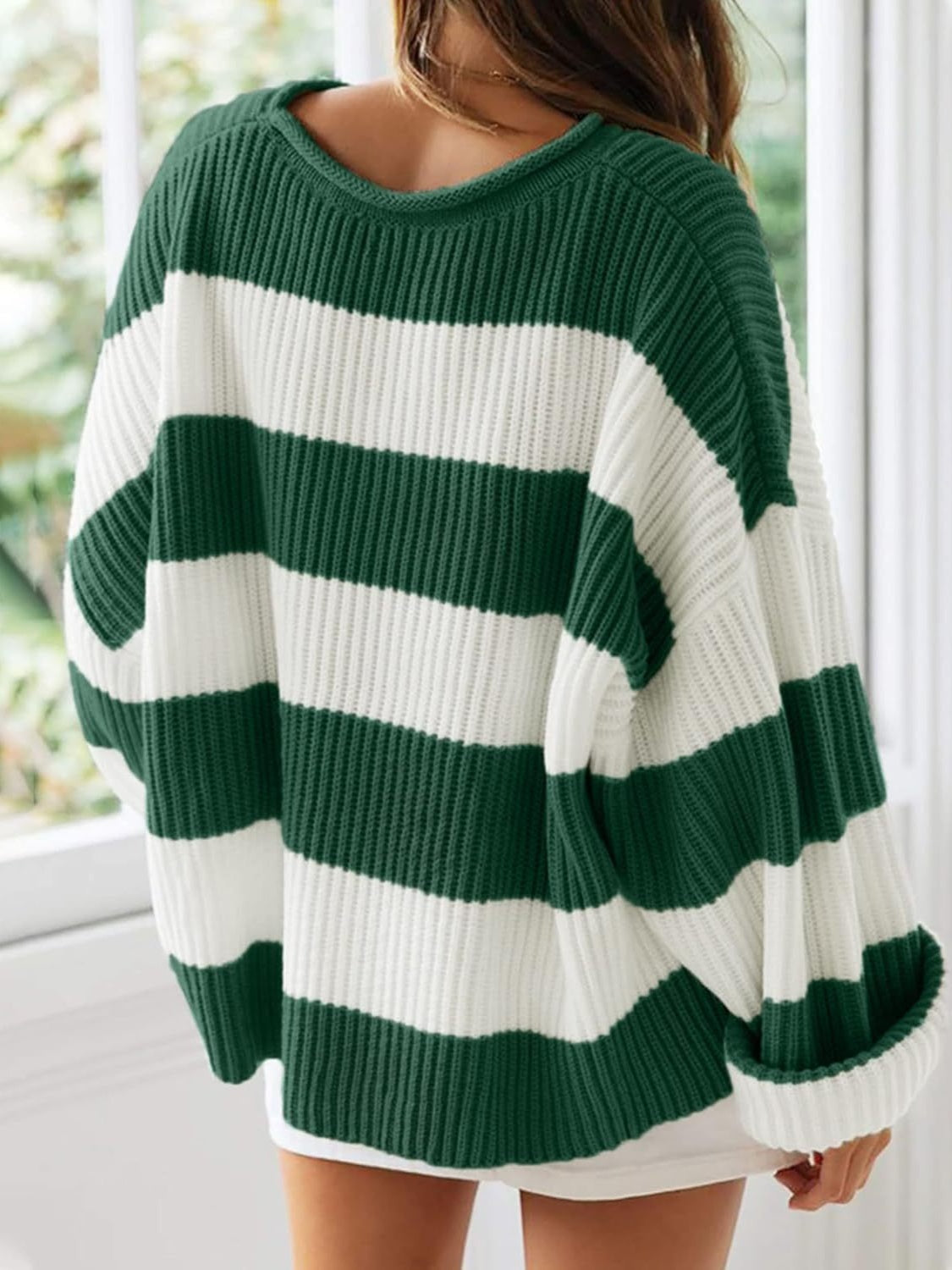 Cozy green striped pullover with a retro-inspired vibe.
