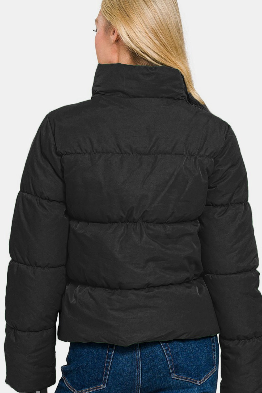 Winter layering with high-neck black puffer jacket for extra warmth
