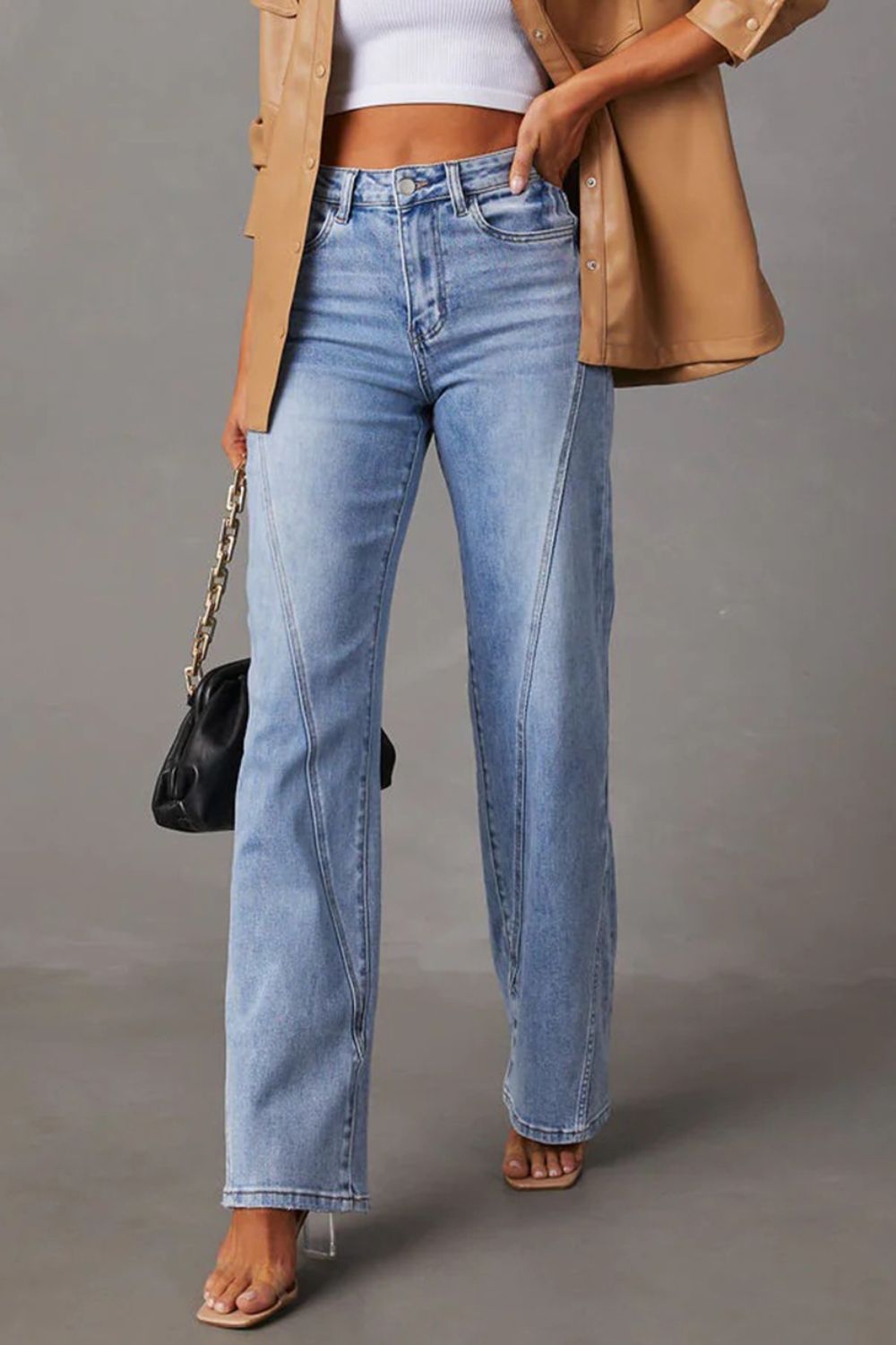 Comfortable high-waist straight jeans with pockets, offering a flattering fit.