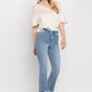 Light wash cropped flare jeans paired with heels for a stylish look.
