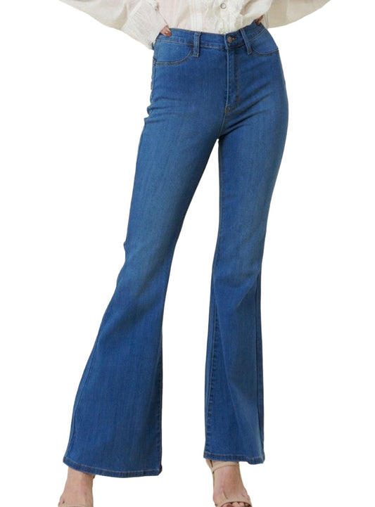 Woman wearing high-rise flare jeans in medium wash.
