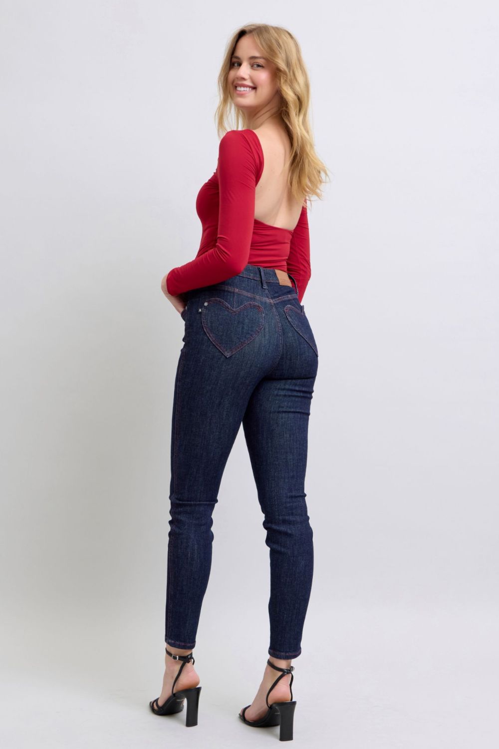 Trendy high-rise skinny jeans with unique heart-shaped back pockets.
