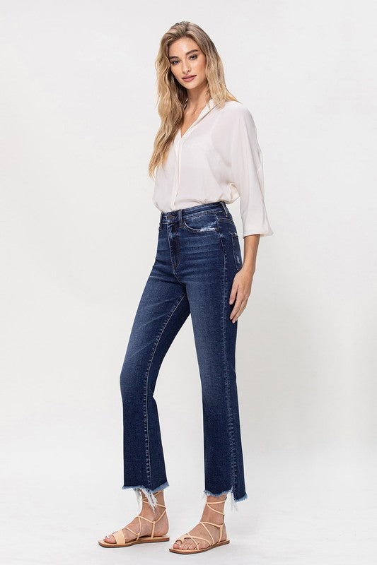 Dark wash flare jeans with a frayed hem, styled for a trendy look.
