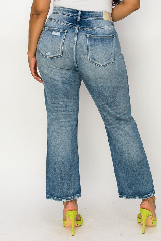 Trendy plus-size stretch denim jeans with distressed details.
