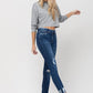 Women's trendy skinny jeans with distressed patches and a cropped fit.