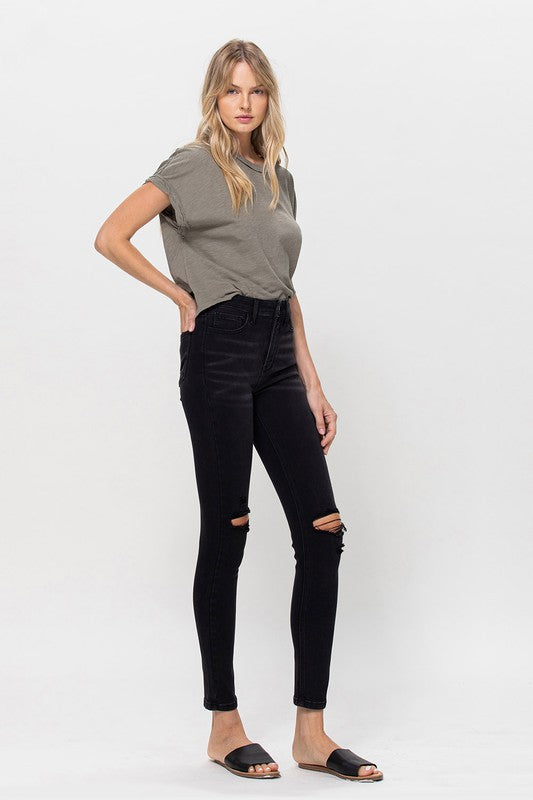 Sleek black high-rise skinny jeans with distressed details
