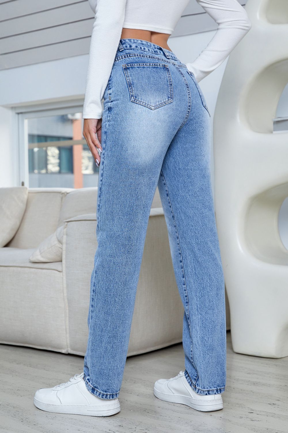 Side view of high-rise slim straight-leg jeans with functional pockets and slight stretch.
