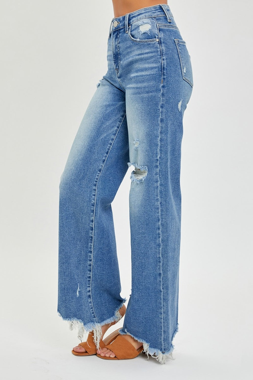 Relaxed-fit wide leg jeans featuring frayed hem and subtle distressing
