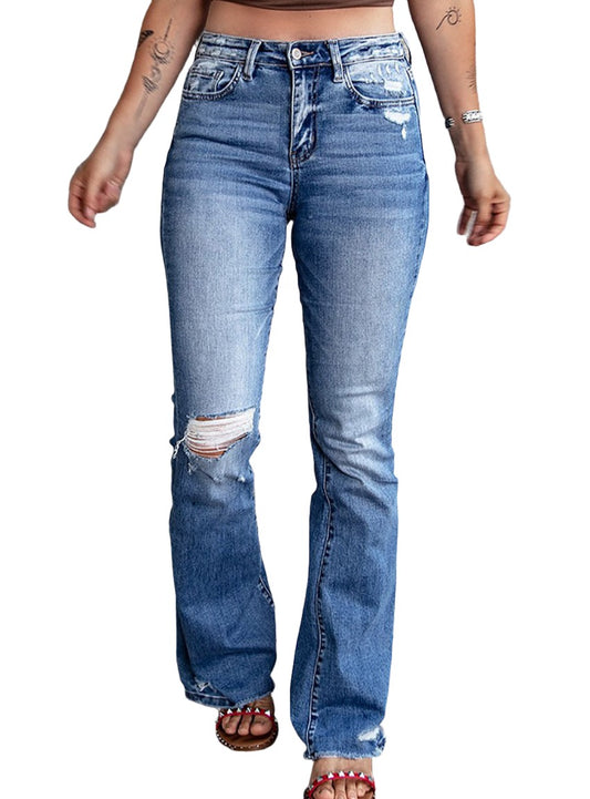 Front view of model in high waist flare jeans with ripped and raw hem details