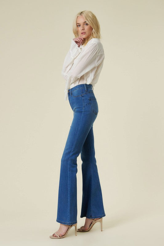 Full-length view of high-rise jeans with flared legs.
