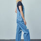 Relaxed-fit cotton denim overalls featuring patch pockets and side button closures.
