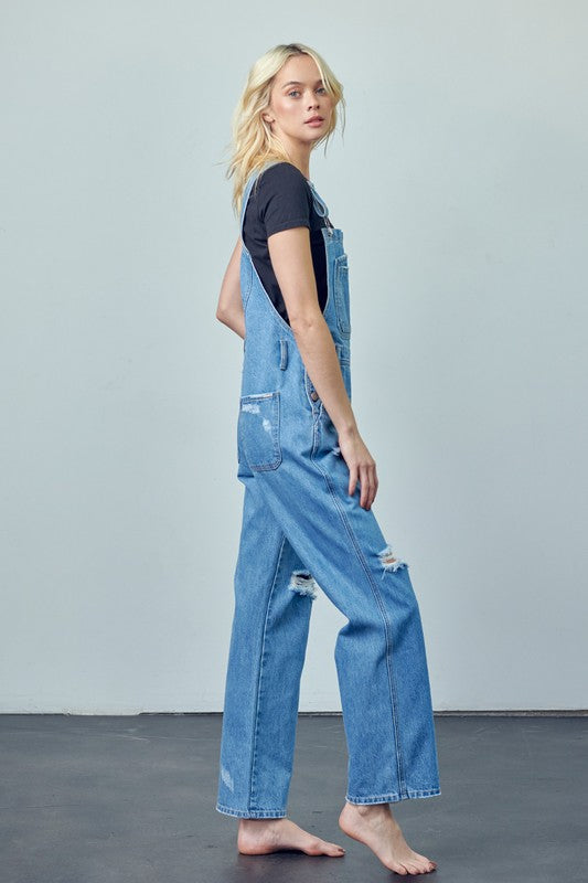 Relaxed-fit cotton denim overalls featuring patch pockets and side button closures.
