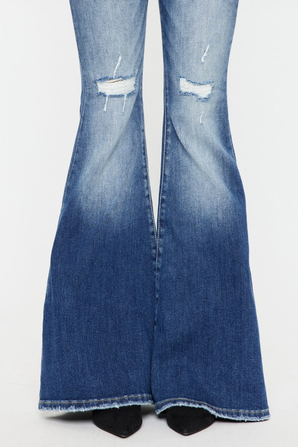 Kancan flare jeans with high-rise fit, distressed details, and raw hem in medium wash.
