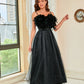 High-waisted formal black dress featuring a feather bodice and mesh details.





