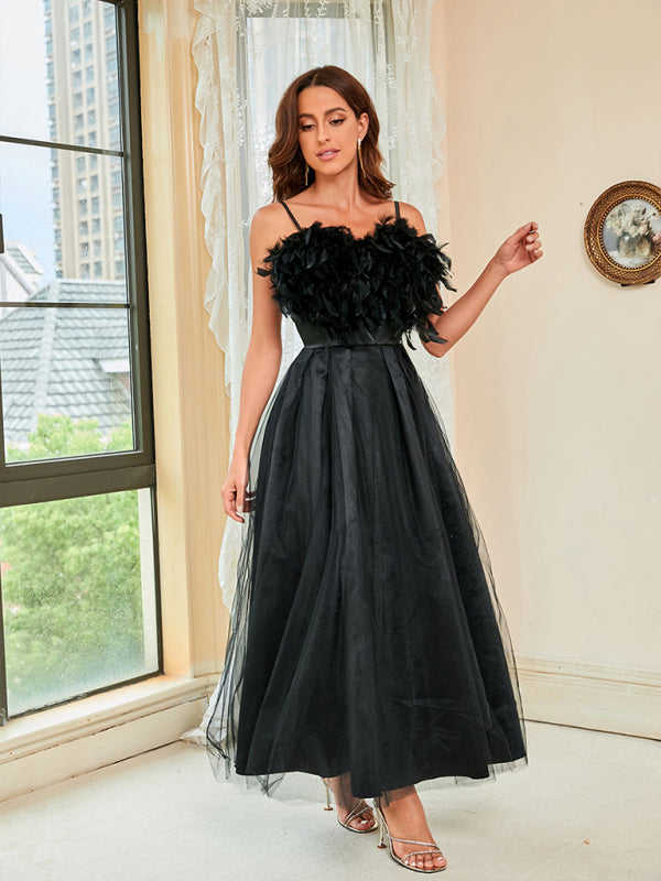 High-waisted formal black dress featuring a feather bodice and mesh details.





