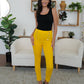 Mustard high-waisted pants with fashionable button details.