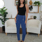 Navy high-waisted pants with chic button details.