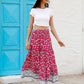 Full-length image of a red floral tiered skirt, perfect for summer outings.
