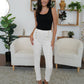 A pair of high-waisted white pants with chic button accents.