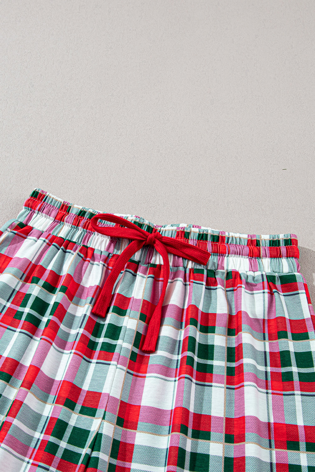 Holiday-themed plaid pajama set ideal for lounging or gift-giving.
