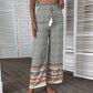 Trendy wide-leg pants with a boho floral and paisley print, perfect for beach days.