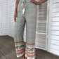 Boho chic wide-leg pants in a colorful floral and paisley print, ideal for casual outings