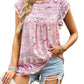 Detailed look at the bohemian floral pattern on a pink top.
