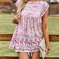 Versatile boho pink floral blouse styled with casual summer accessories.