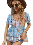 Model wearing a floral peplum top with short sleeves and playful tassels, ideal for a boho chic look.