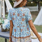 Woman styling a light blue floral peplum top with orange details, perfect for casual outings.