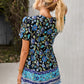 Vibrant blue and black floral peplum blouse with white tassels, perfect for festivals.