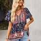 Woman in a lightweight floral top with boho tassels, styled for a casual outing.