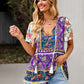 Purple floral peplum blouse with colorful patterns, paired with ripped denim shorts.