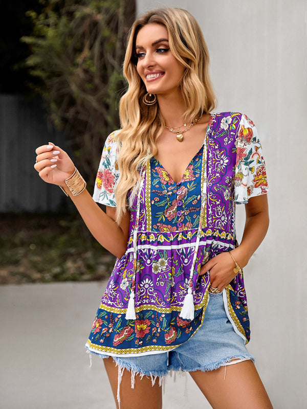 Purple floral peplum blouse with colorful patterns, paired with ripped denim shorts.