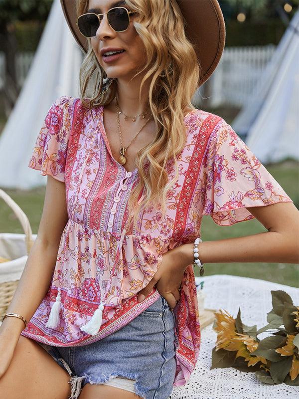 Elegant floral print peplum top with short sleeves, styled for a summer day out.
