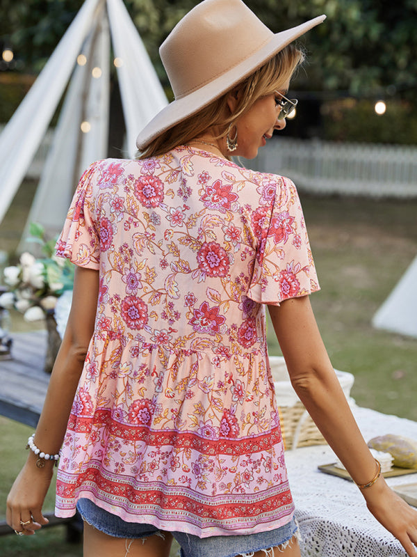 Model wearing a floral peplum top with short sleeves and playful tassels, ideal for a boho chic look.