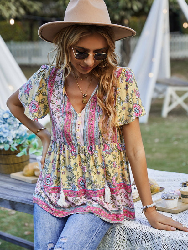 Casual floral peplum blouse in yellow and pink, styled with relaxed jeans.