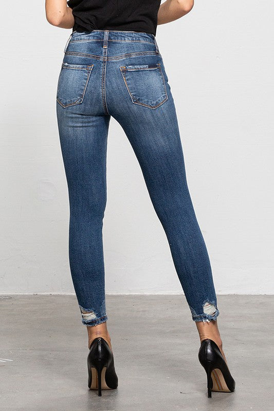 Back view of Insane Gene mid-rise ankle skinny jeans in blue denim with distressed detailing.