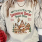 Soft ivory sweatshirt with gingerbread house design, perfect for winter holidays.