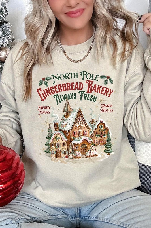 Soft ivory sweatshirt with gingerbread house design, perfect for winter holidays.