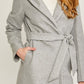 Pocket detail on gray fleece belted hoodie coat for women
