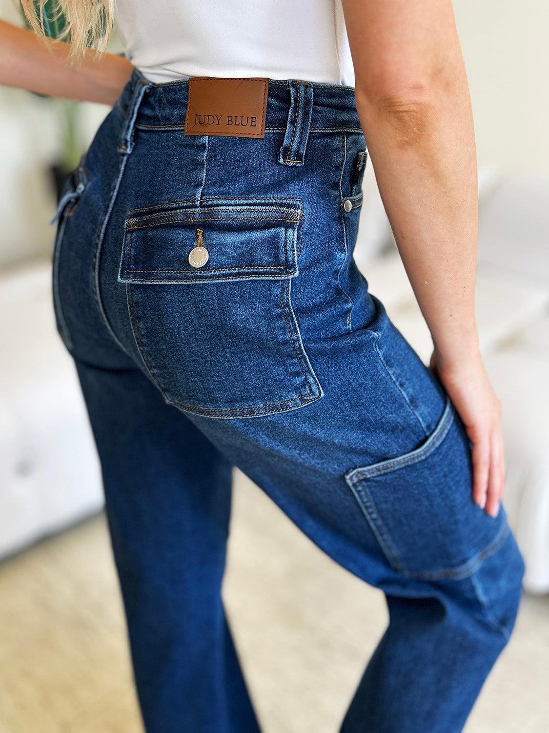 Judy Blue jeans with cargo pockets and logo patch, back view.