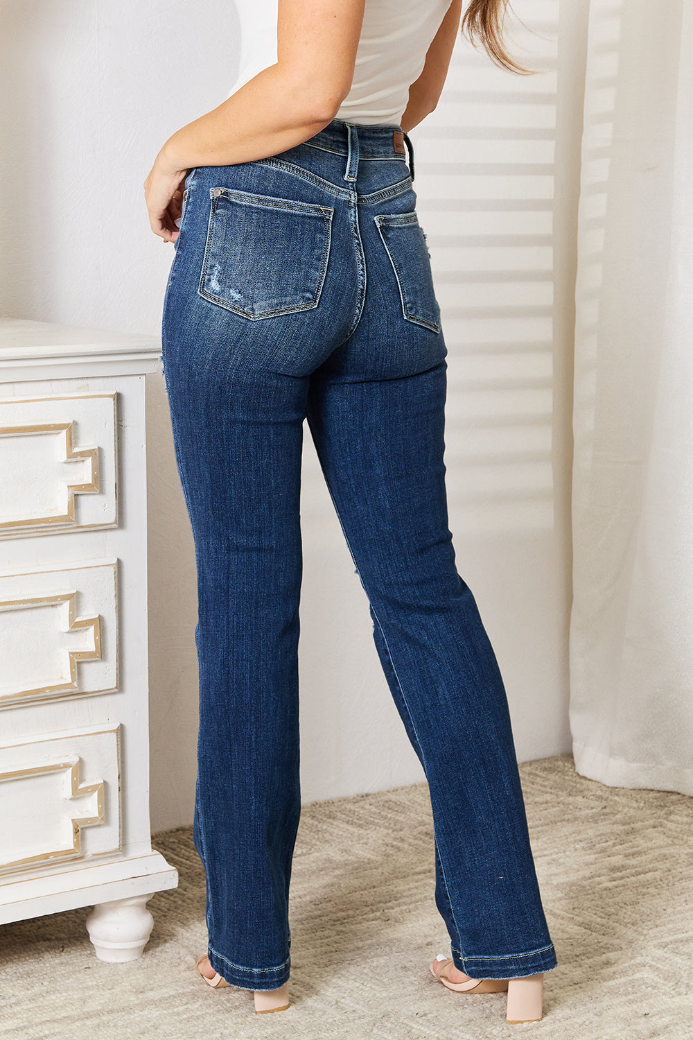 Judy Blue Mid-Rise Bootcut Jeans with Distressed Details.